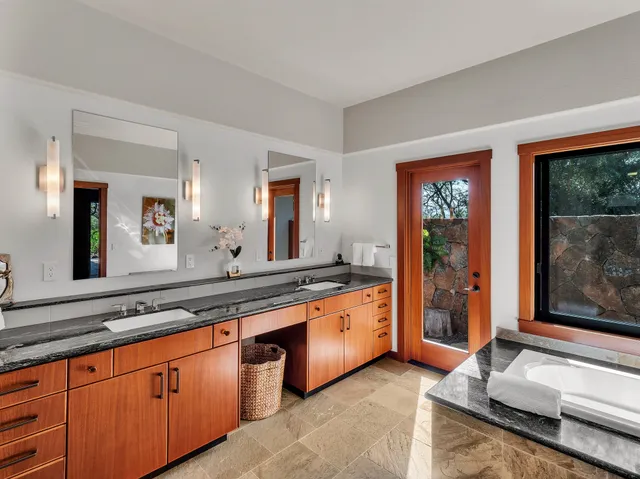a large bathroom with a large mirror and a sink