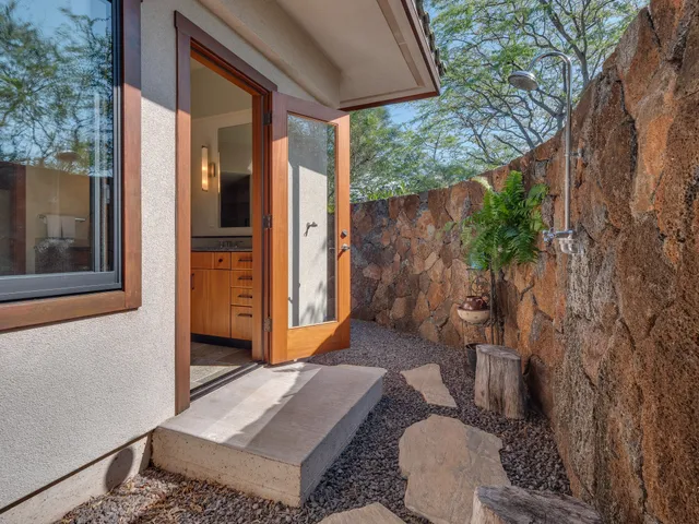 a backyard of a house with outdoor seating