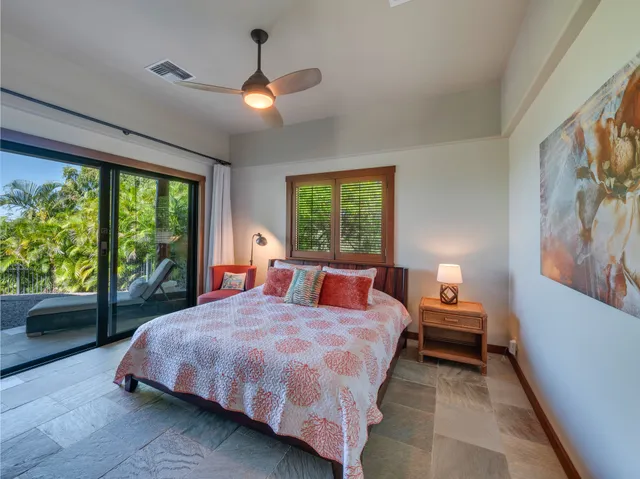 a bedroom with a bed and a large window with outer view