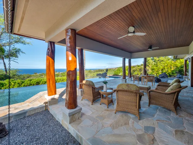 a living room with patio furniture and garden view