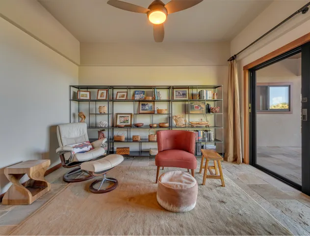 a living room with furniture a rug and a window