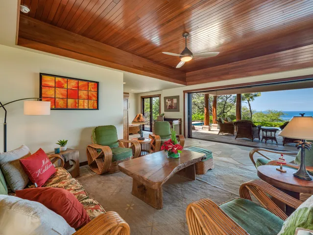 a living room with furniture a rug and a large window