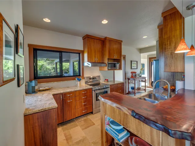 a kitchen with counter top space a sink and appliances