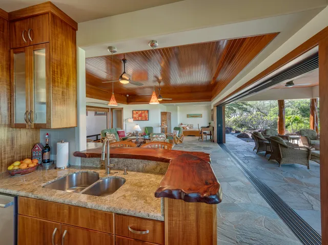 a kitchen with sink refrigerator and large window