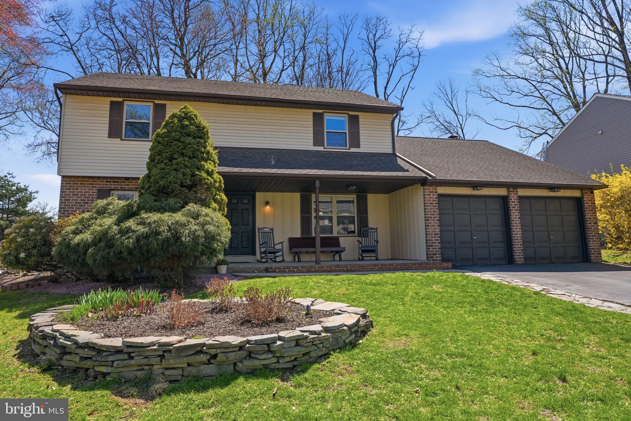 a front view of a house with a yard garage and outdoor seating