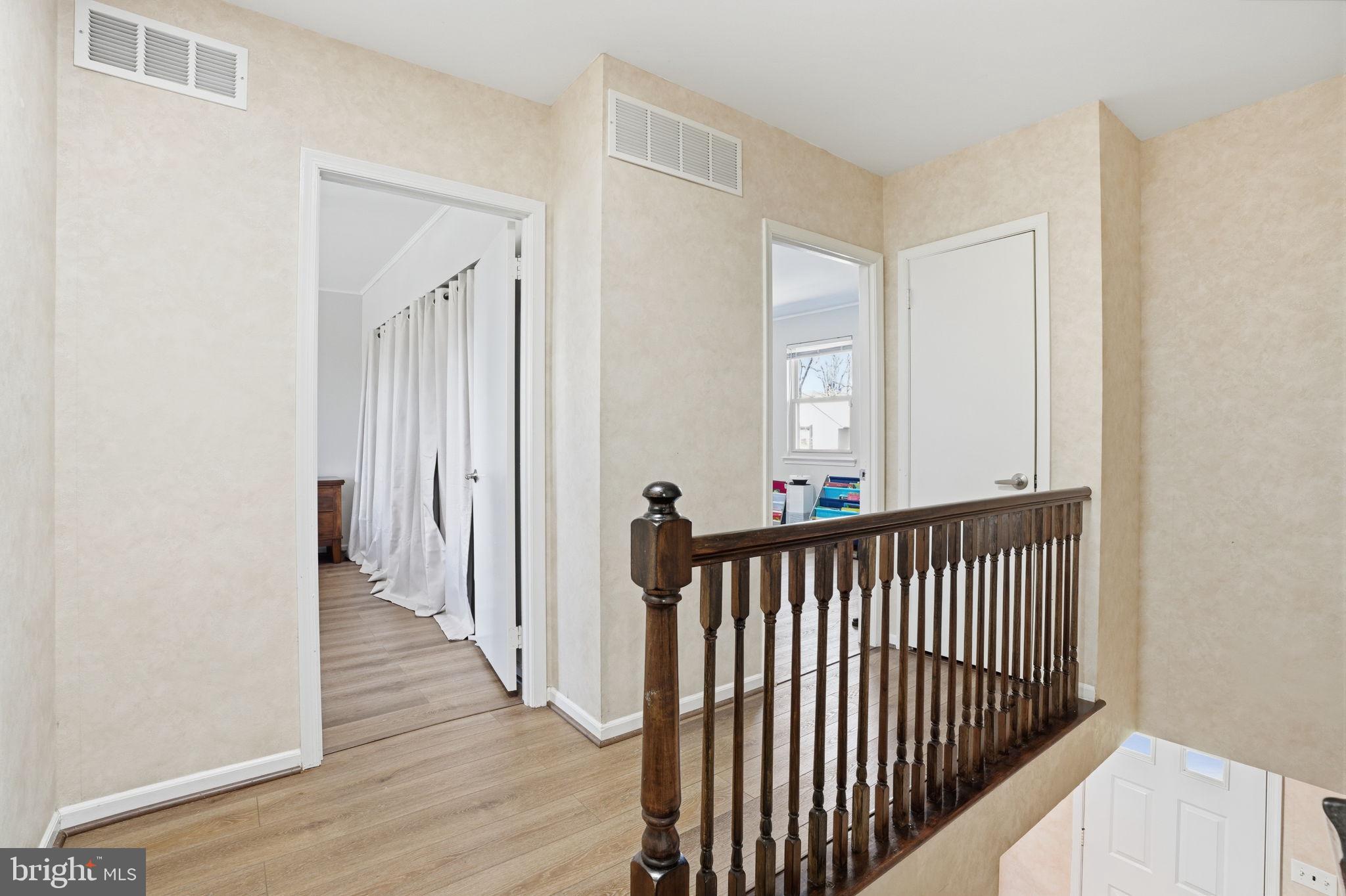739 Bridgeview Road Feasterville-Trevose, PA 19053 - Photo 26 of 46 a view of a hallway with wooden floor and a bathroom
