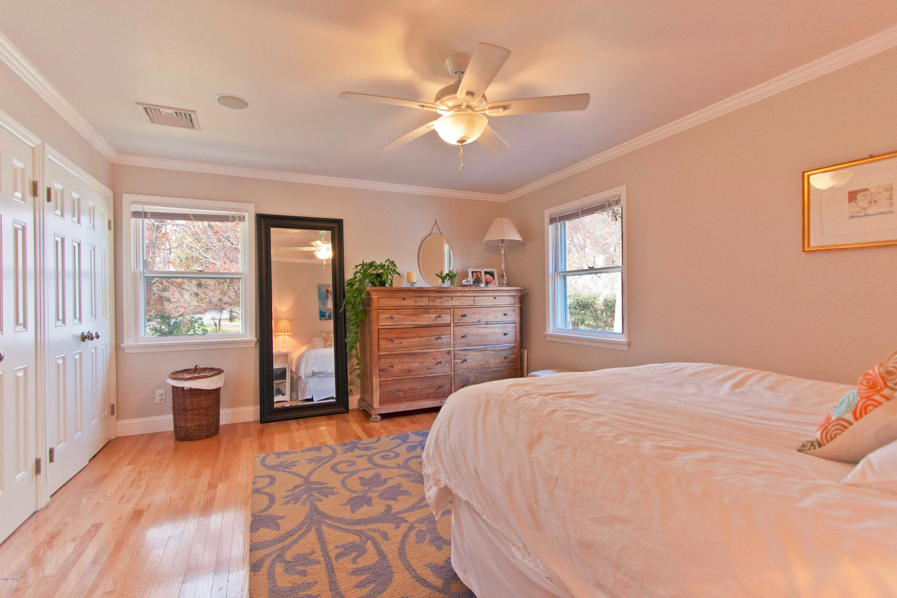41 Indian Field Road Greenwich, CT 06830 - Photo 11 of 20 a bedroom with a large bed and a chandelier