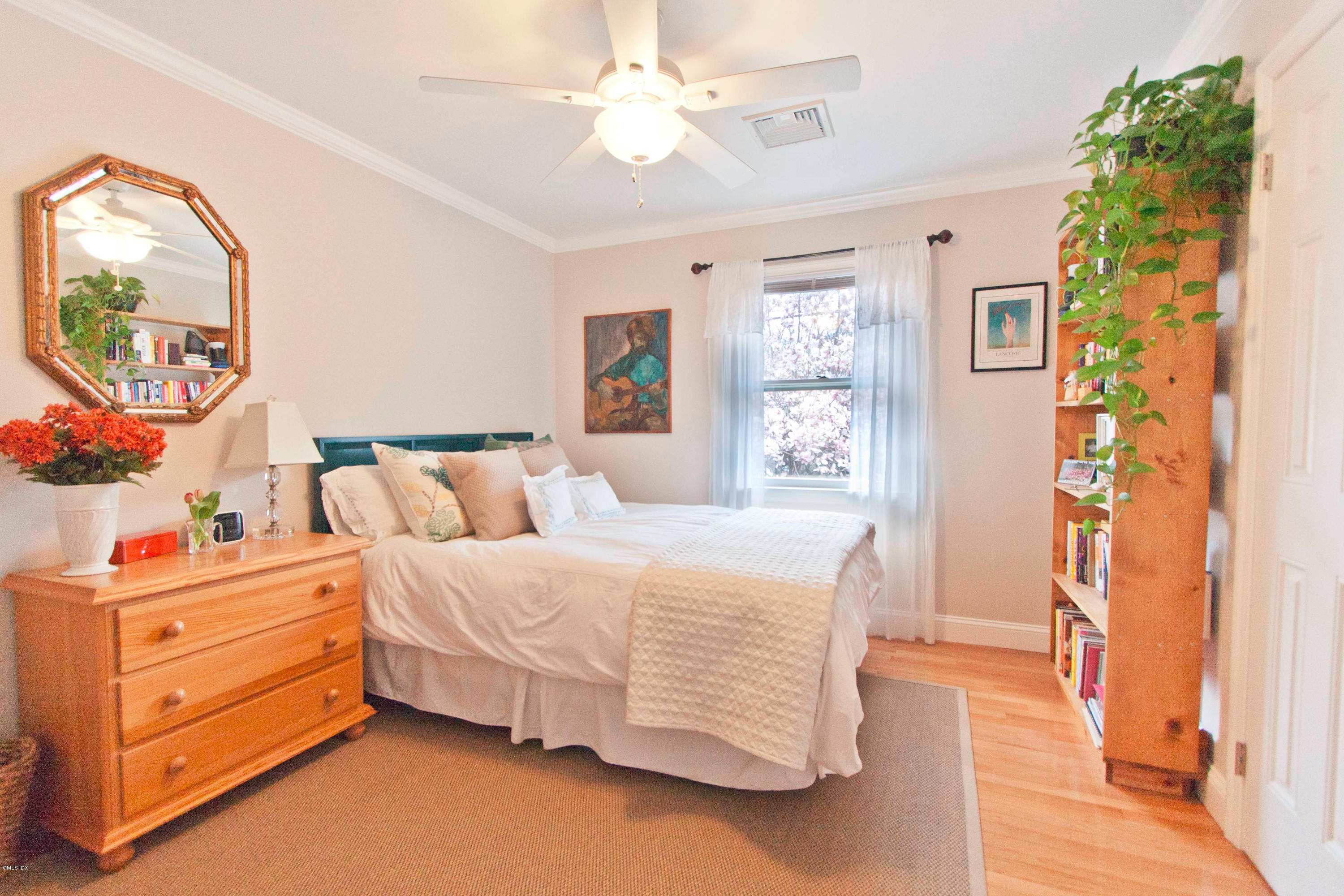 41 Indian Field Road Greenwich, CT 06830 - Photo 13 of 20 a bedroom with a bed dresser and a window