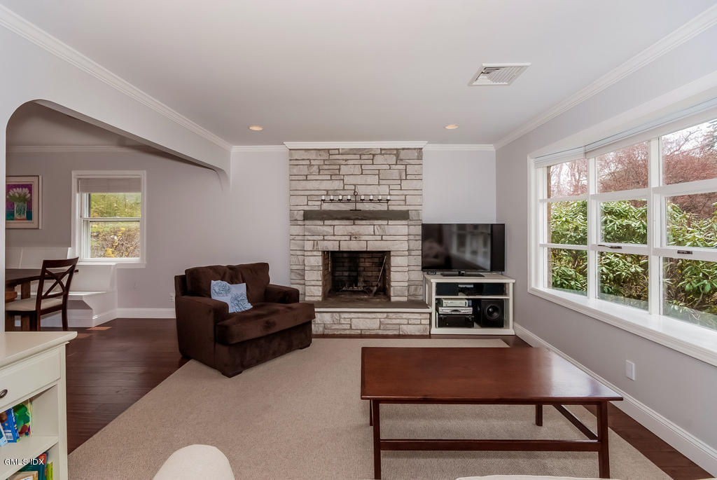 41 Indian Field Road Greenwich, CT 06830 - Photo 5 of 20 a living room with furniture a flat screen tv and a fireplace