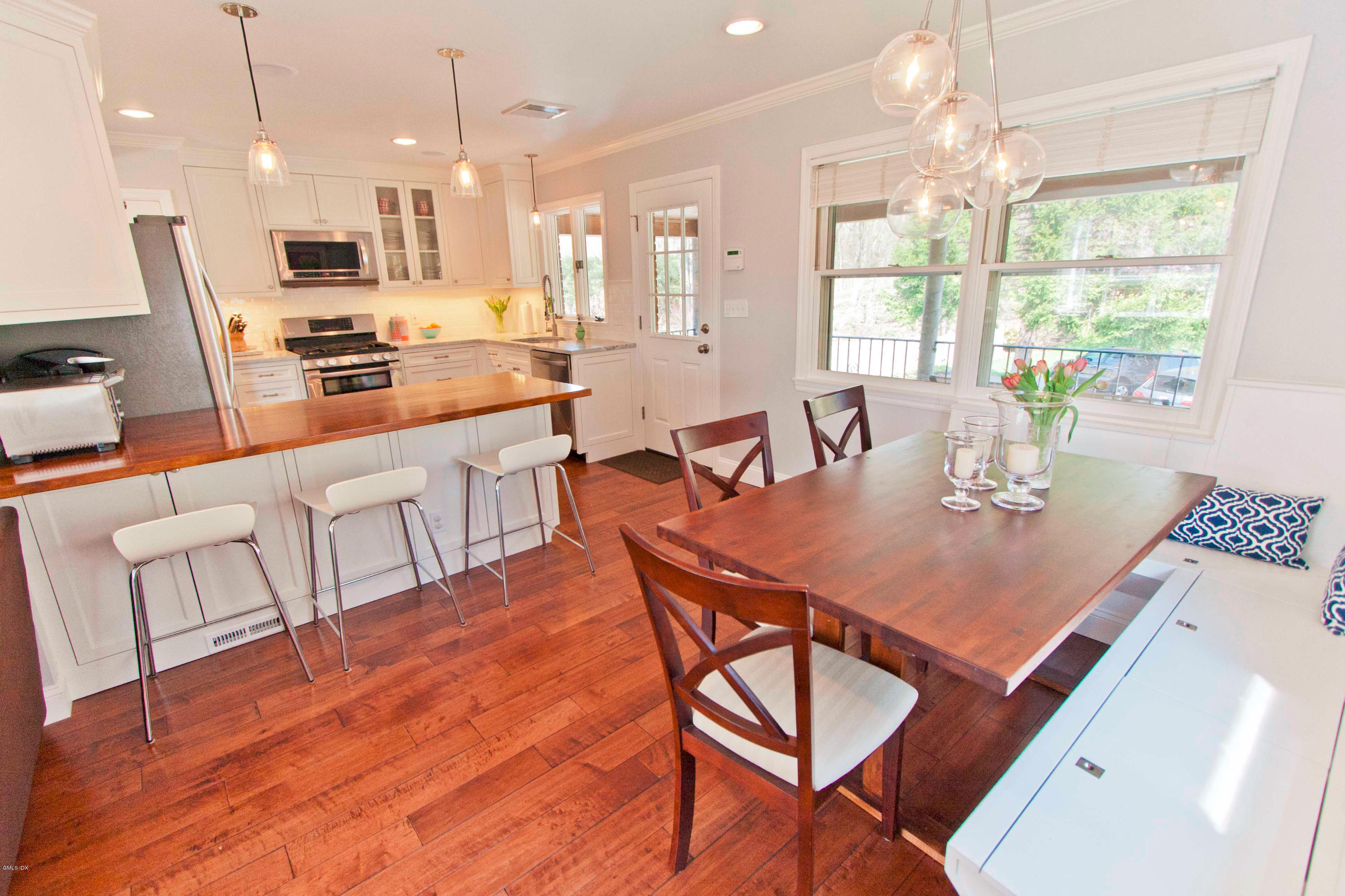 41 Indian Field Road Greenwich, CT 06830 - Photo 6 of 20 a kitchen with stainless steel appliances a dining table chairs and couches