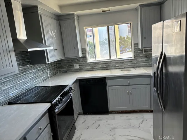 a kitchen with a refrigerator and a sink