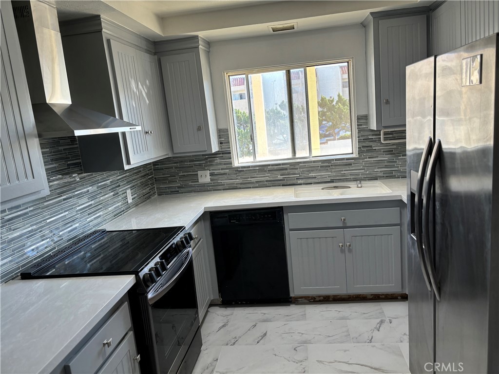 a kitchen with a refrigerator and a sink