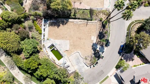 an aerial view of a house with outdoor space and a lake view