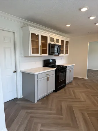 a kitchen with stainless steel appliances granite countertop a stove and a sink