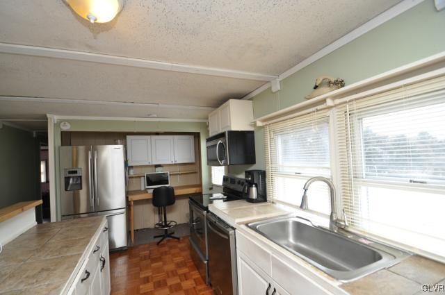 417 North Penn Dixie Road Bath, PA 18014 - Photo 11 of 25 a kitchen with a sink cabinets and outdoor space