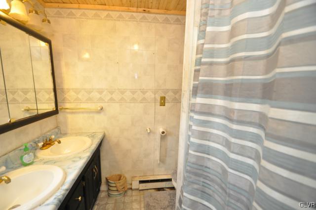 417 North Penn Dixie Road Bath, PA 18014 - Photo 21 of 25 a bathroom with a granite countertop sink and a shower