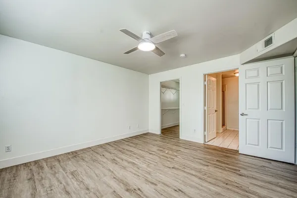 a view of empty room with wooden floor