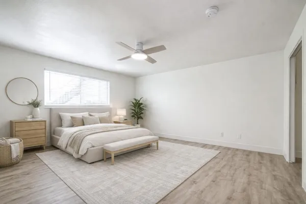 a spacious bedroom with a large bed and a chandelier