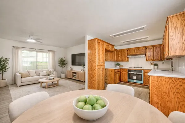 a living room with furniture a large window and a fireplace