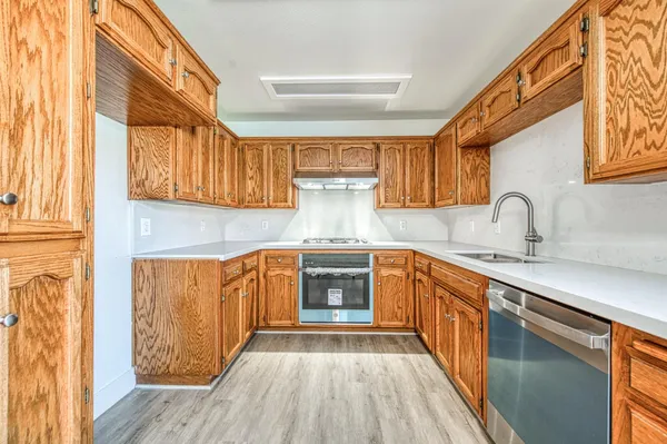 a kitchen with stainless steel appliances a stove a sink and a microwave