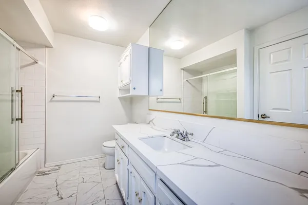 a bathroom with a sink toilet and shower