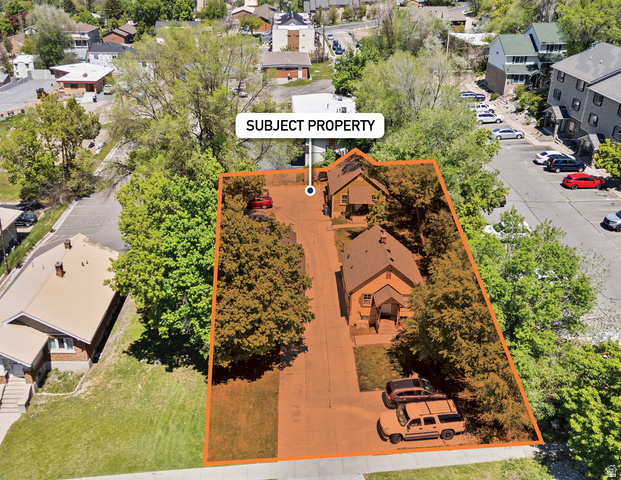 661 East 600 North Logan, UT 84321 - Photo 2 of 15 Aerial view showcasing a parcel with two detached residential structures, mature trees, and paved driveways