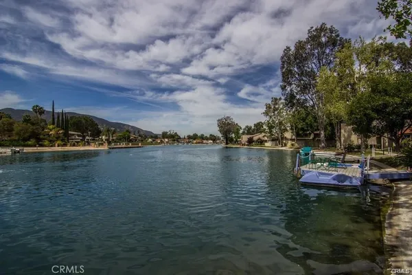 a view of lake with boats and trees around