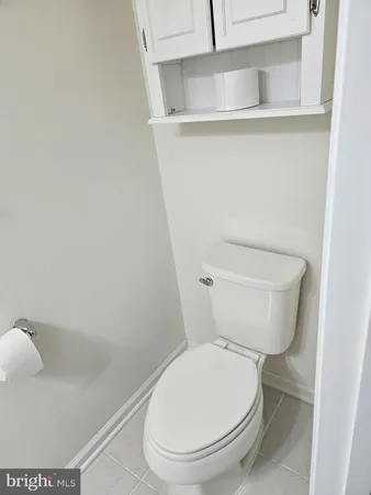 a white toilet sitting next to a shower