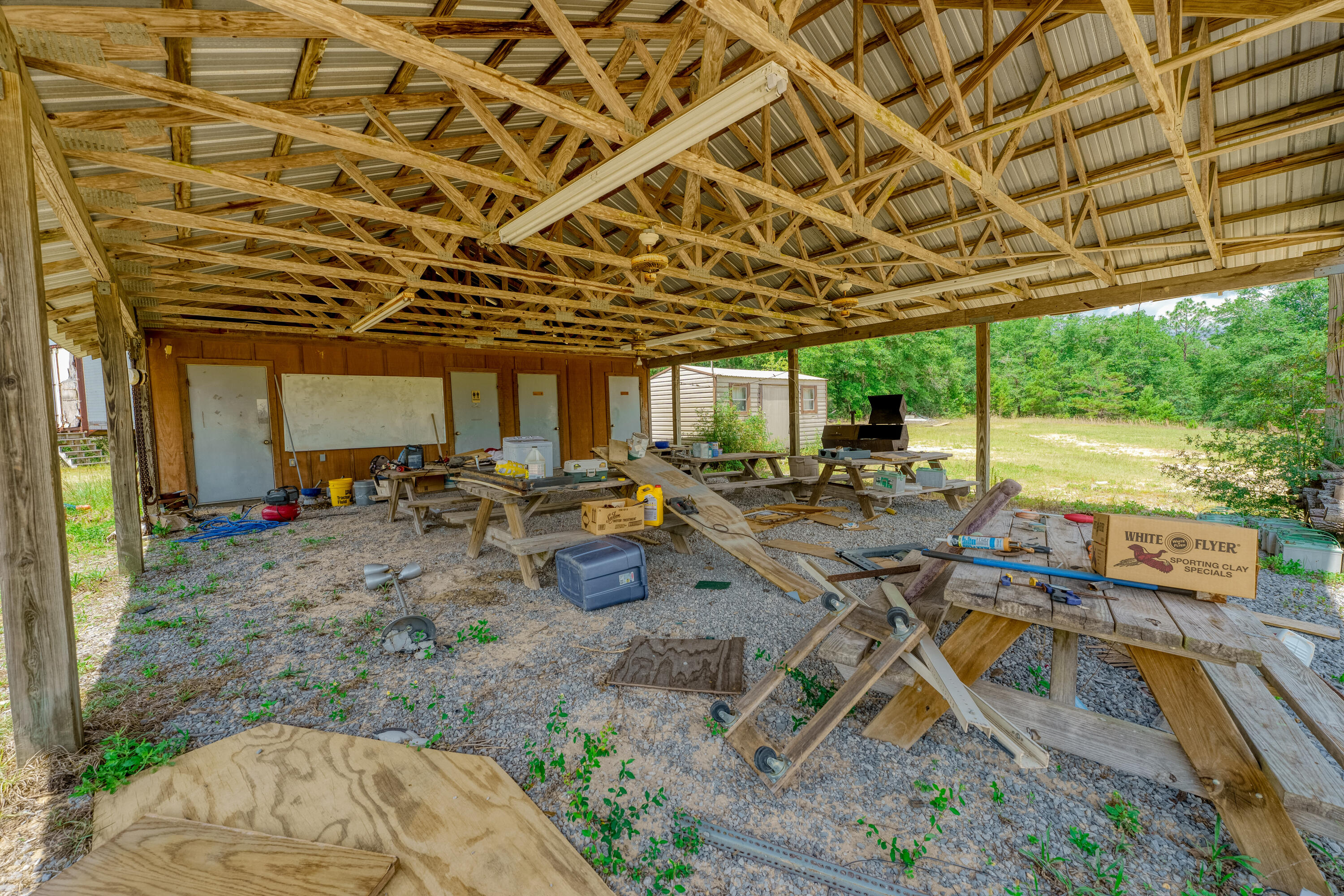 3985 US 90 Crestview, FL 32539 - Photo 18 of 20 a view of a backyard with lawn chairs and plants
