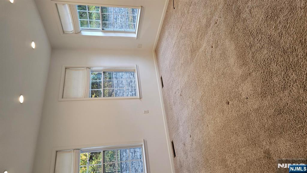 188 Aspen Drive, Unit 414 Cedar Grove, NJ 07009 - Photo 11 of 23 an empty room with windows