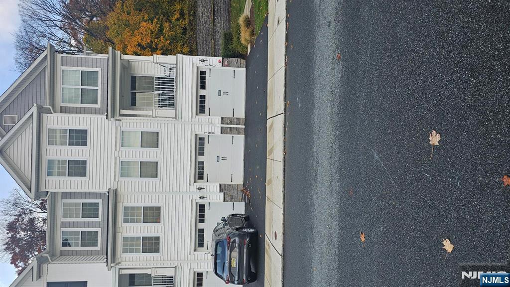 188 Aspen Drive, Unit 414 Cedar Grove, NJ 07009 - Photo 22 of 23 a white building with a street