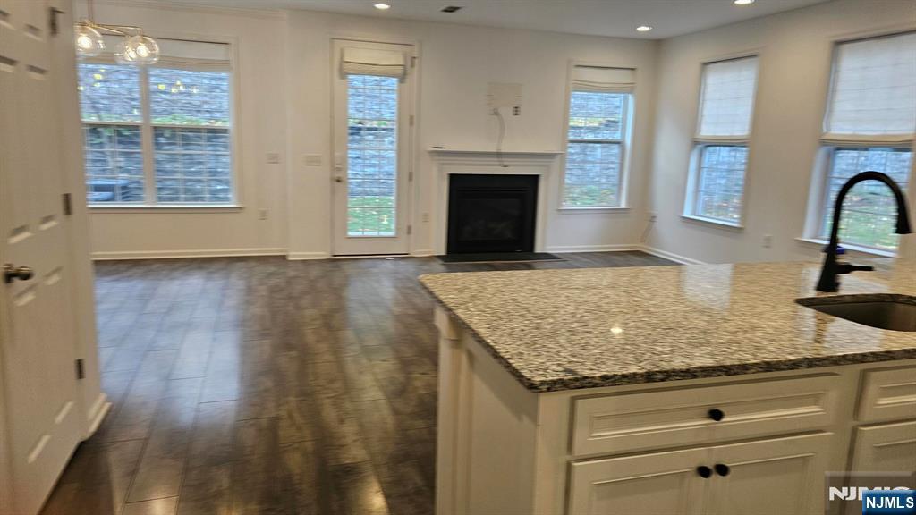 188 Aspen Drive, Unit 414 Cedar Grove, NJ 07009 - Photo 3 of 23 a view of kitchen with granite countertop cabinets and outdoor space