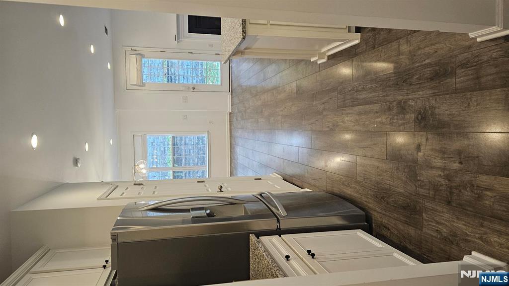 188 Aspen Drive, Unit 414 Cedar Grove, NJ 07009 - Photo 6 of 23 a view of a refrigerator in kitchen and wooden floor