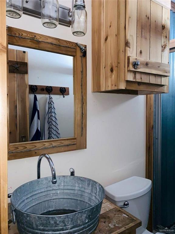 2938 Highway 83 Roma, TX 78584 - Photo 16 of 23 Bathroom featuring vanity and toilet