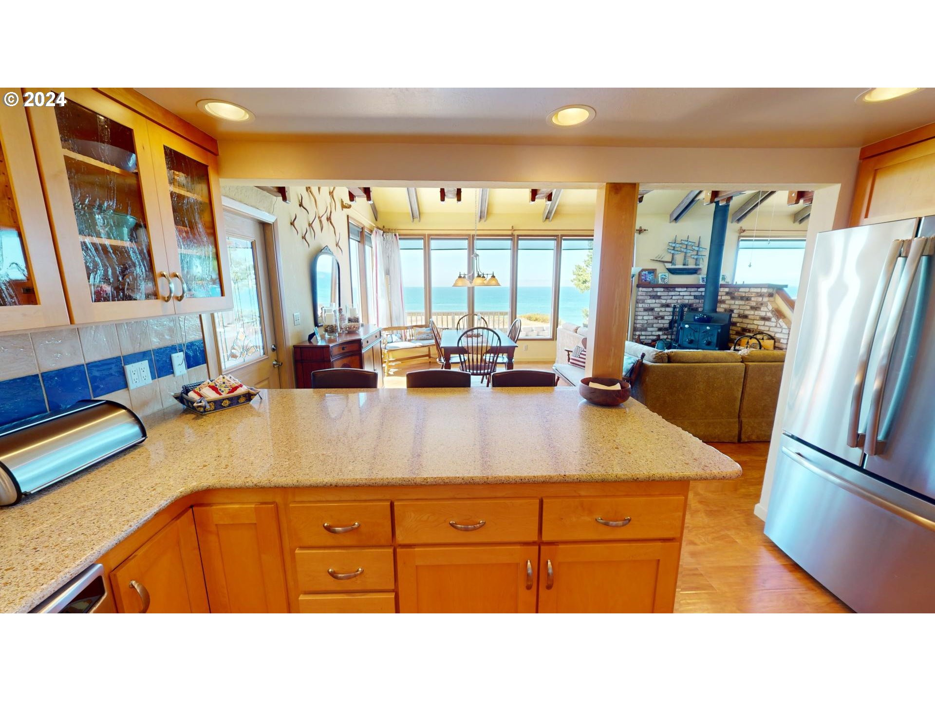 42512 Gull Road Port Orford, OR 97465 - Photo 16 of 41 a kitchen with stainless steel appliances kitchen island granite countertop a refrigerator and a sink