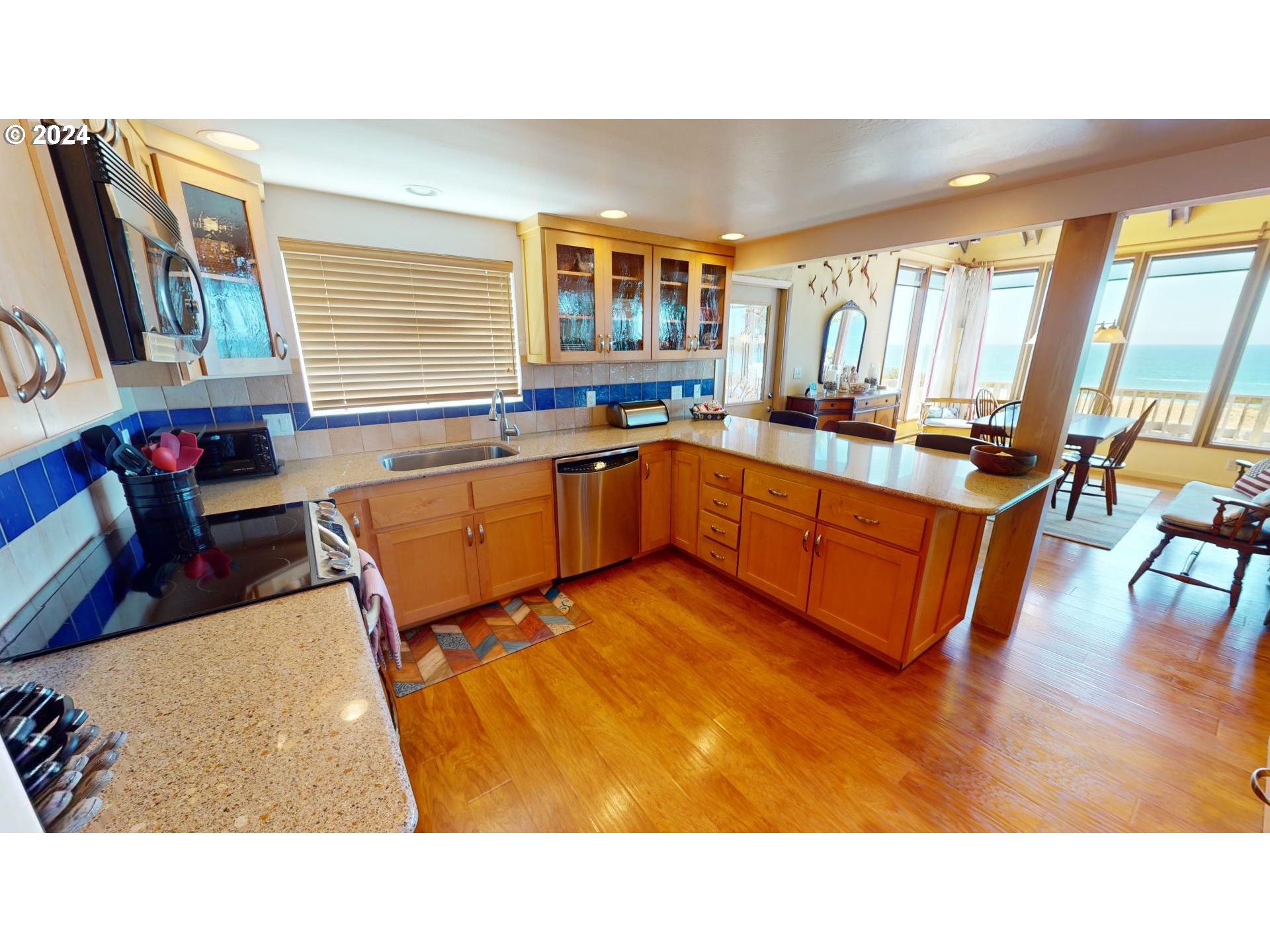 42512 Gull Road Port Orford, OR 97465 - Photo 17 of 41 a kitchen with stainless steel appliances granite countertop a sink and wooden floors