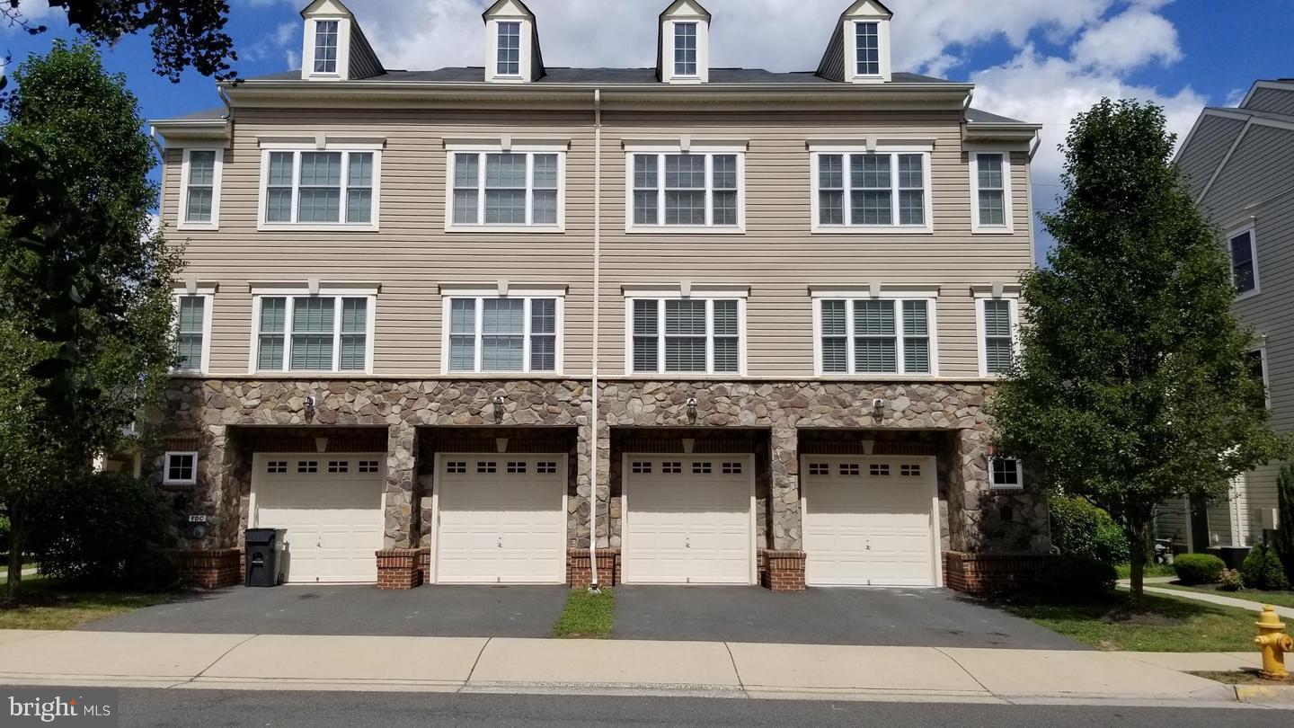 11224 Wortham Crest Circle Manassas, VA 20109 - Photo 1 of 3 a front view of a building with a garden
