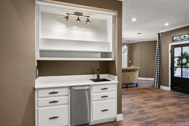 a living room with furniture a fireplace and kitchen view