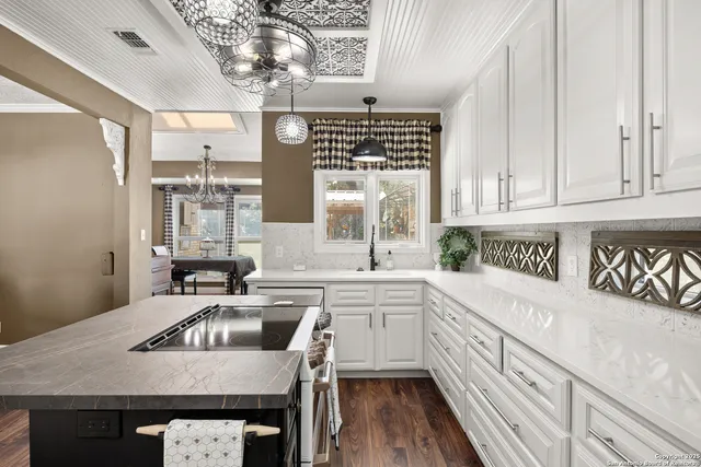 a kitchen with a sink cabinets and stainless steel appliances