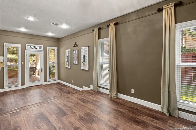 a view of an empty room with glass door
