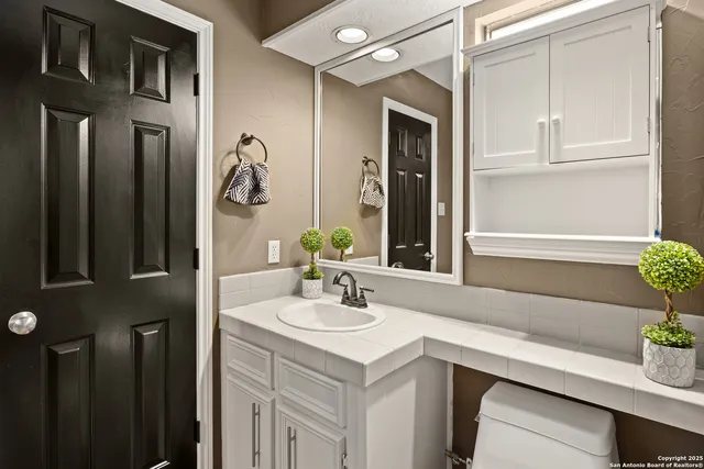 a bathroom with a shower and a glass door