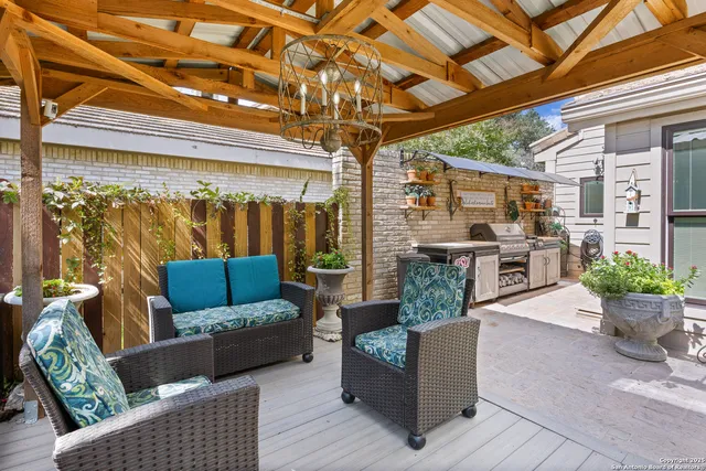 a patio view with a table and chairs and potted plants