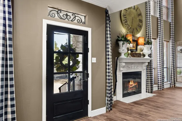 a living room with furniture a fireplace and a chandelier