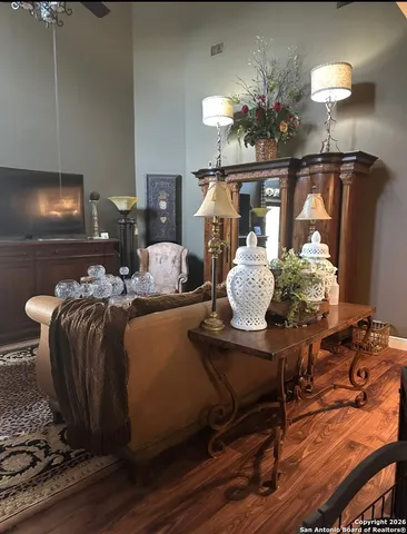 a living room with furniture a fireplace and a chandelier