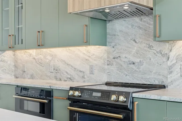 a stove top oven sitting inside of a kitchen