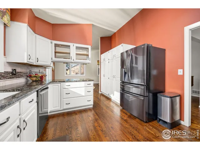 a kitchen with stainless steel appliances a refrigerator sink and cabinets