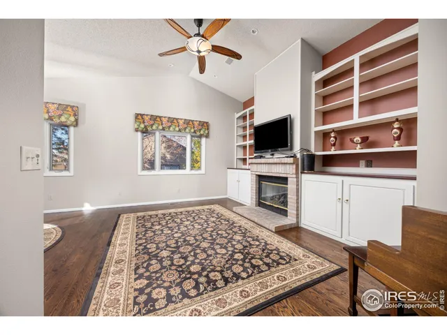 a living room with a flat screen tv and a fireplace