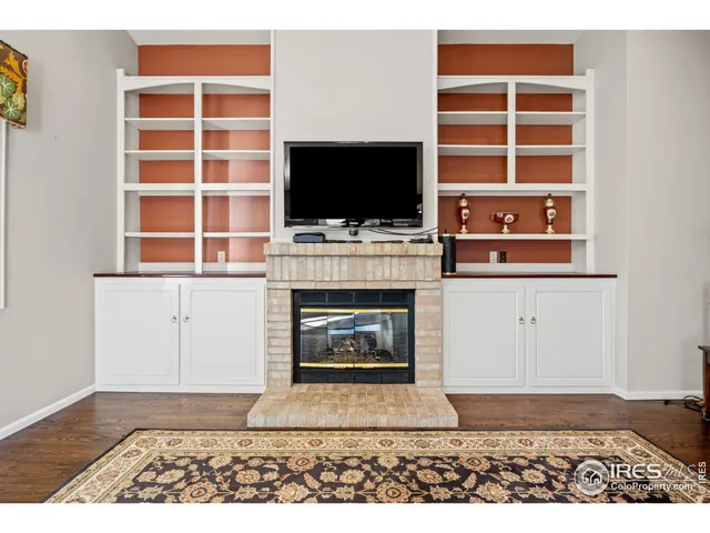 a living room with a fireplace and a flat screen tv