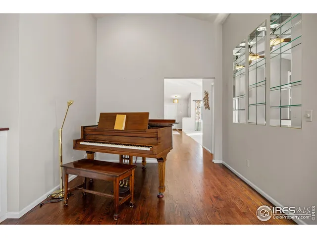 a view of a hallway with wooden floor and a chandelier