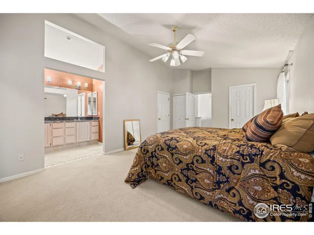 a spacious bedroom with a bed and a chandelier